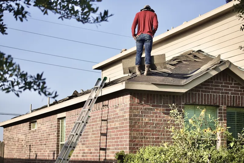 Professional roofer working on a residential roof in Rockland Woods